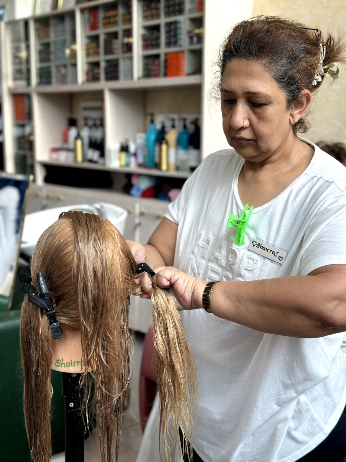 Hair dressing student showing her skills on a dummy during Masterclass session.