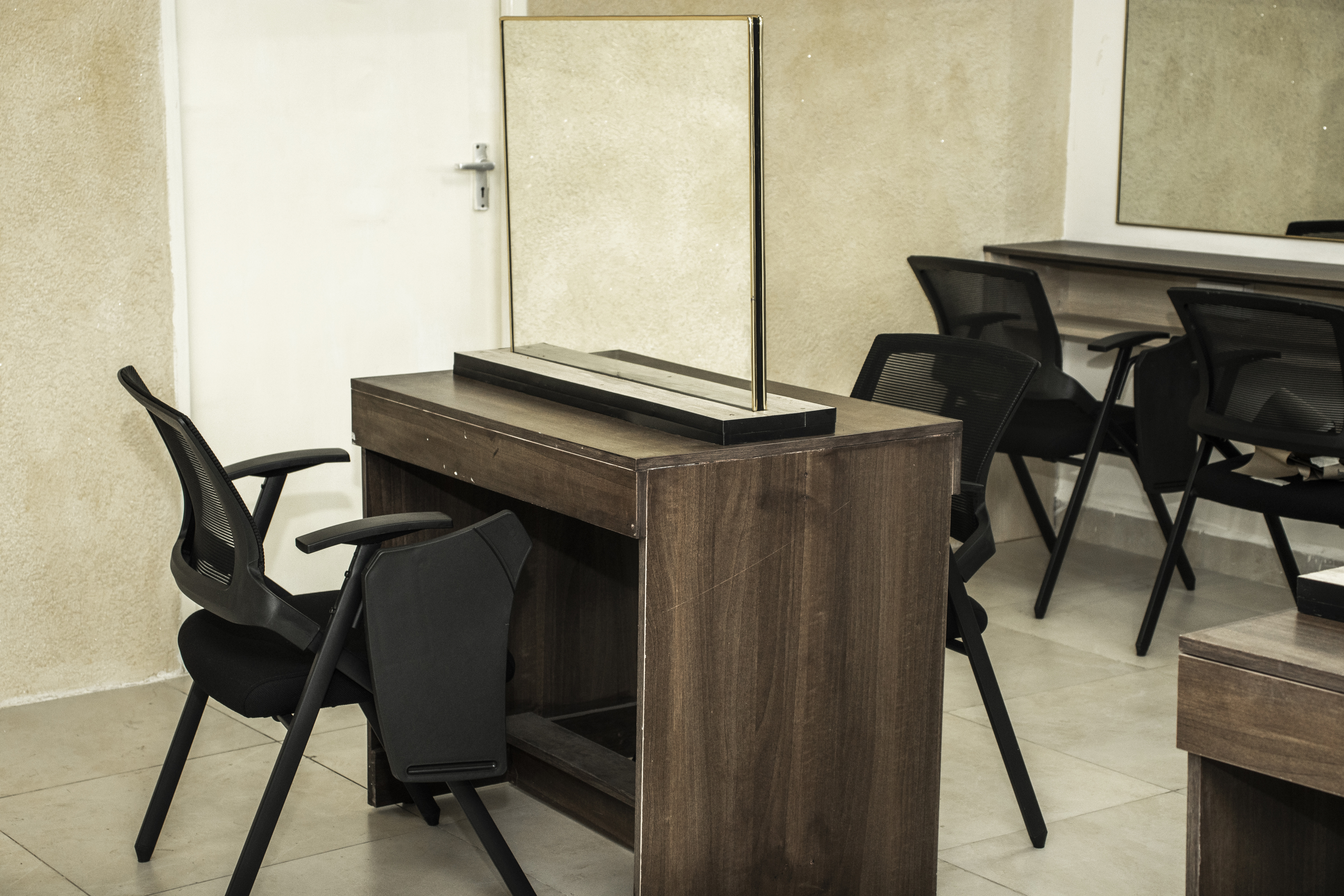 Picture showing a desk with a mirror attached on it.